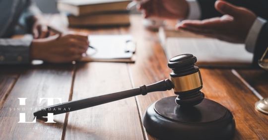 lawyer helping client at table